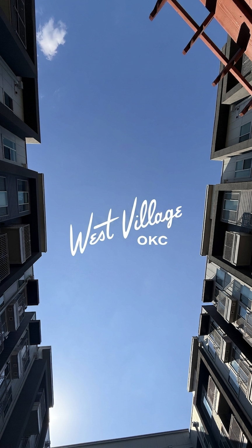 West Village OKC social graphic looking up between two buildings